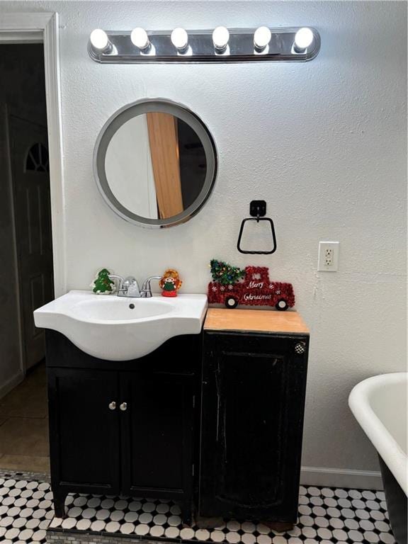 bathroom with a washtub and vanity