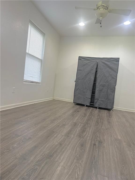 spare room featuring hardwood / wood-style floors and ceiling fan