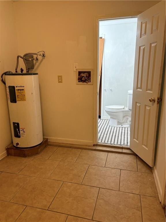 interior space with electric water heater and light tile patterned floors