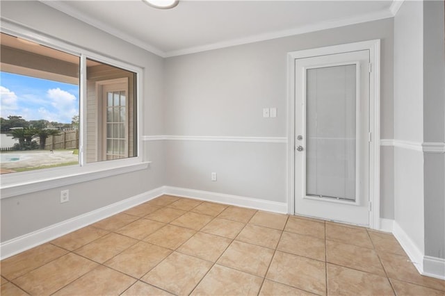 tiled spare room featuring crown molding