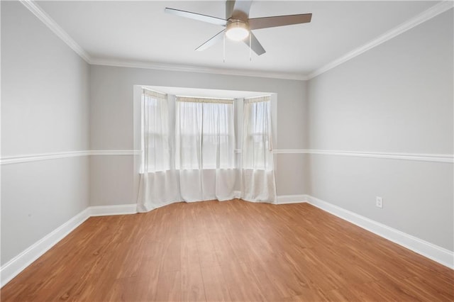 spare room featuring ceiling fan, wood-type flooring, and ornamental molding