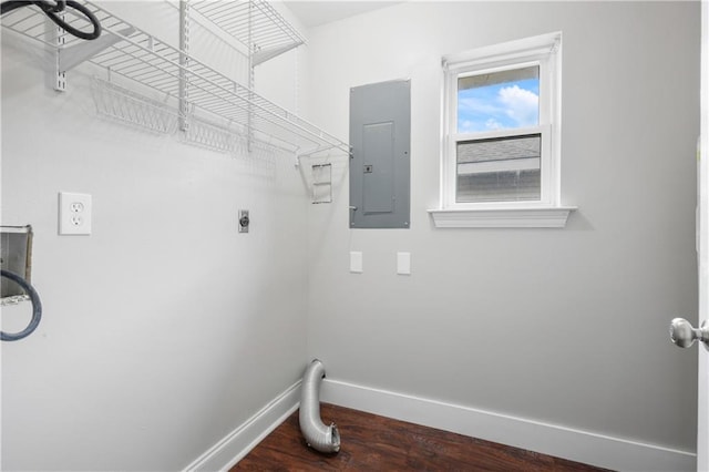 clothes washing area with electric dryer hookup, dark wood-type flooring, and electric panel