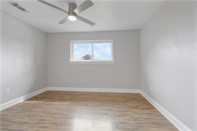 empty room featuring light wood-type flooring and ceiling fan