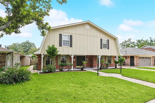 view of front facade featuring covered porch, a garage, and a front yard