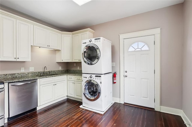 clothes washing area with stacked washer / dryer, sink, and dark hardwood / wood-style flooring