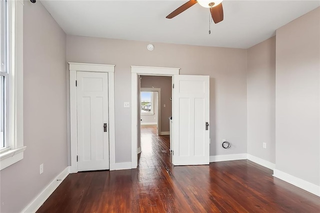 spare room featuring ceiling fan and dark wood-type flooring