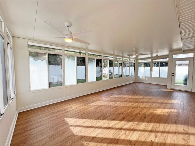 unfurnished sunroom with ceiling fan