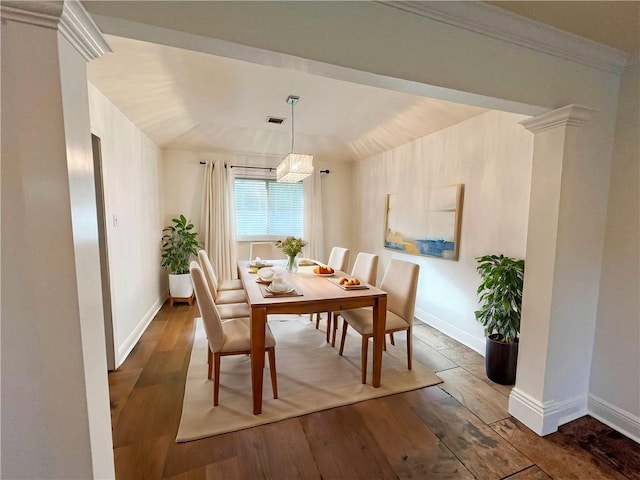 dining space featuring vaulted ceiling, an inviting chandelier, and dark wood-type flooring