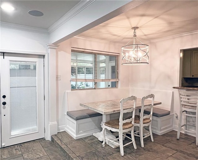 dining area featuring a notable chandelier, breakfast area, plenty of natural light, and ornamental molding