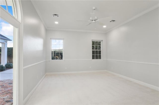 unfurnished room featuring light colored carpet, ceiling fan, and ornamental molding