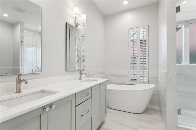 bathroom featuring vanity and separate shower and tub