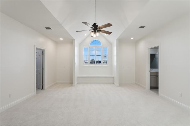 carpeted spare room with ceiling fan and lofted ceiling