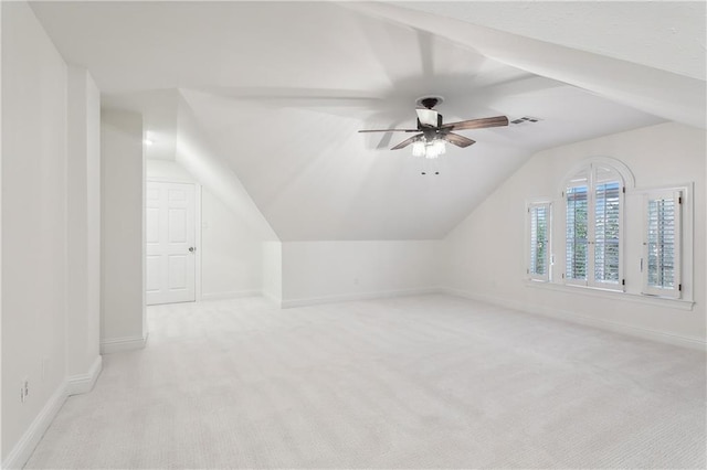 bonus room with light carpet, ceiling fan, and vaulted ceiling