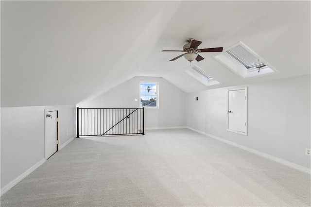 additional living space featuring ceiling fan, light carpet, and vaulted ceiling