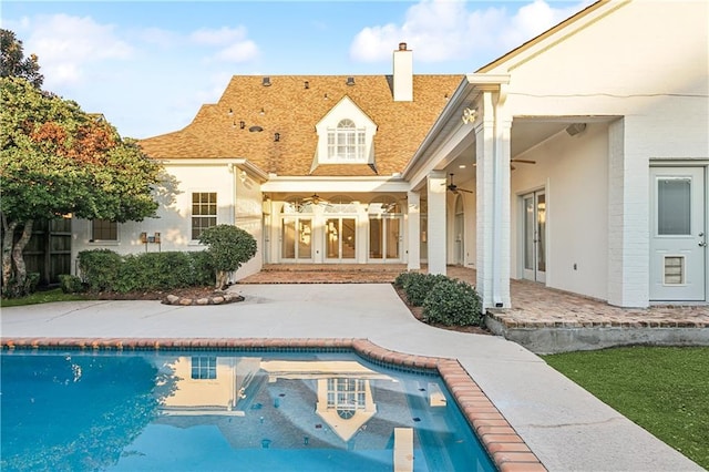 rear view of house with ceiling fan, a patio area, and french doors