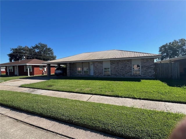 ranch-style house featuring a front yard and a carport