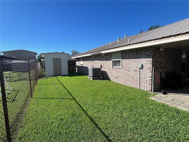 view of yard featuring central AC unit and a storage shed