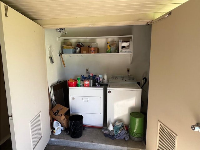 clothes washing area featuring separate washer and dryer