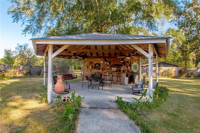 view of community featuring a gazebo, a patio area, an outdoor bar, and a yard