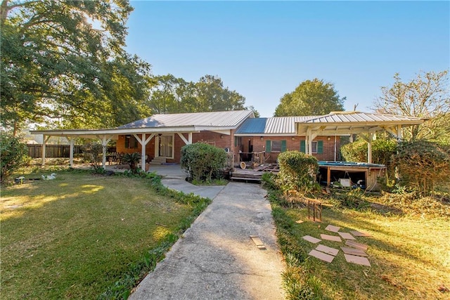 view of front of property with a carport and a front lawn