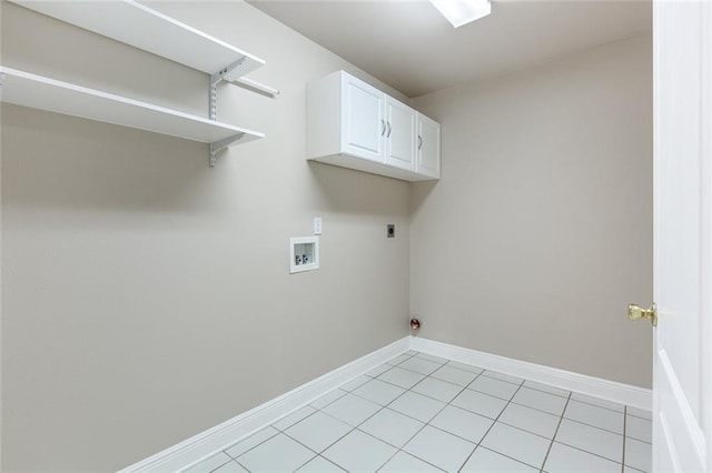 clothes washing area featuring electric dryer hookup, cabinets, light tile patterned flooring, and washer hookup