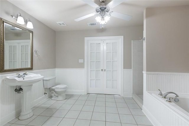 bathroom featuring tile patterned floors, ceiling fan, toilet, and independent shower and bath