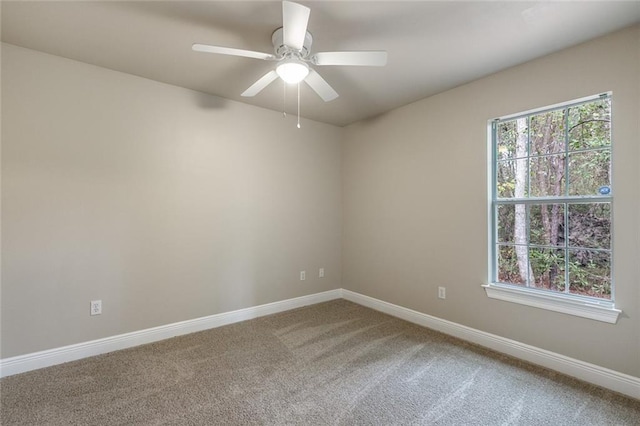 carpeted spare room with ceiling fan