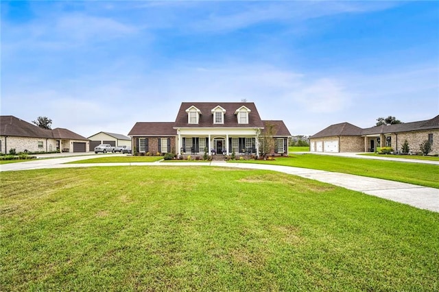 cape cod house featuring covered porch and a front yard