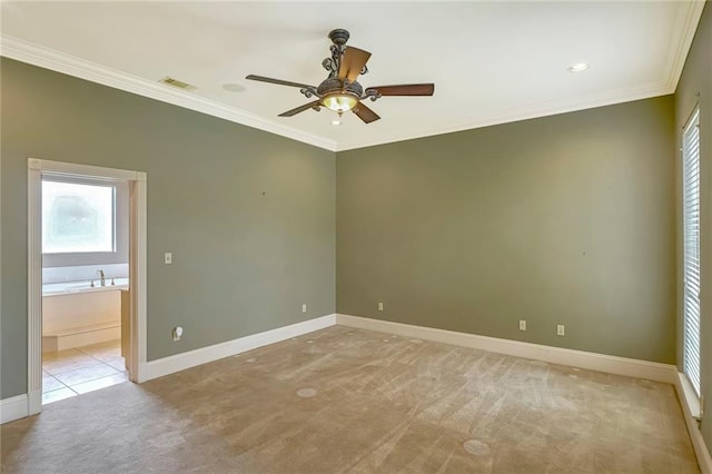 carpeted spare room with crown molding and ceiling fan