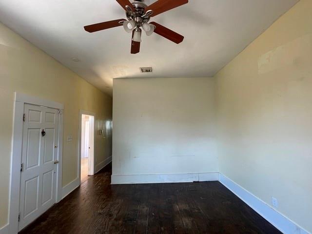 spare room featuring dark hardwood / wood-style floors and ceiling fan