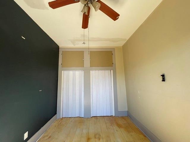 unfurnished room featuring ceiling fan and light wood-type flooring