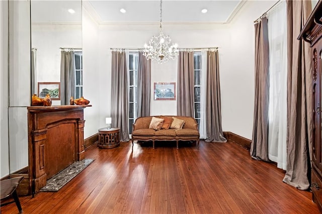 sitting room featuring hardwood / wood-style floors, a notable chandelier, and crown molding