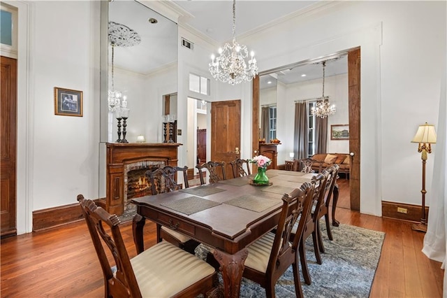 dining space with light hardwood / wood-style flooring and ornamental molding