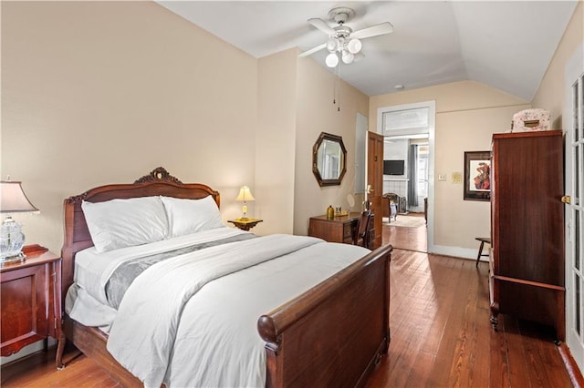 bedroom with dark hardwood / wood-style flooring, ceiling fan, and lofted ceiling