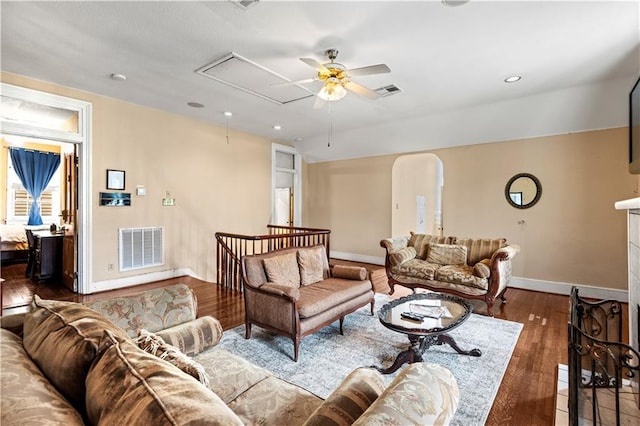 living room featuring ceiling fan and dark wood-type flooring