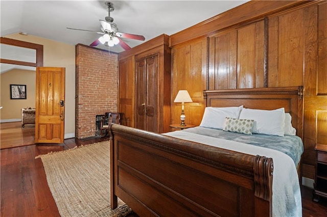 bedroom featuring ceiling fan, dark hardwood / wood-style flooring, and lofted ceiling