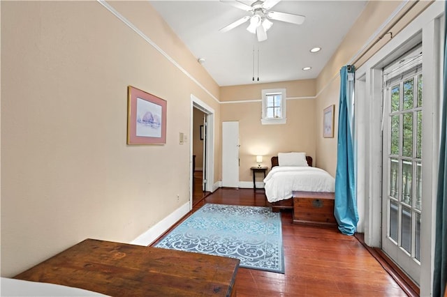 bedroom with access to exterior, dark hardwood / wood-style floors, multiple windows, and ceiling fan