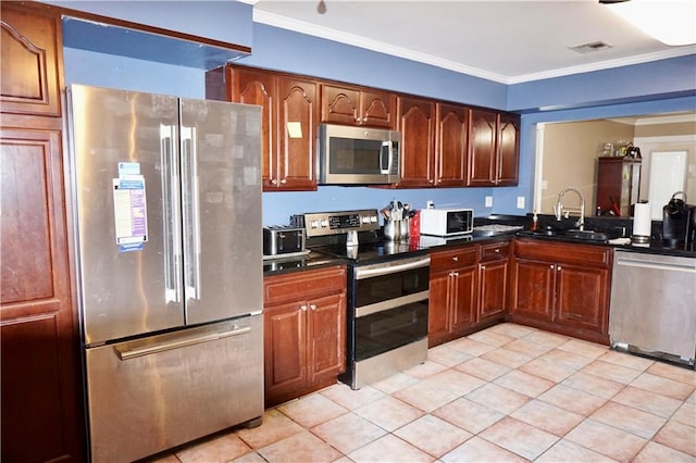 kitchen with light tile patterned floors, ornamental molding, sink, and appliances with stainless steel finishes