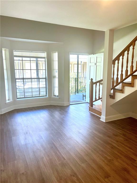 unfurnished living room featuring dark wood-type flooring