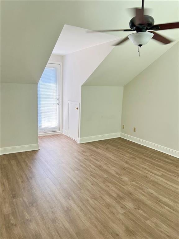 additional living space with hardwood / wood-style flooring, ceiling fan, and lofted ceiling