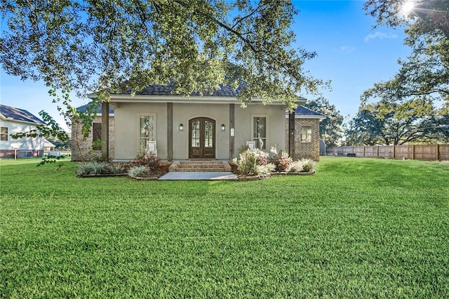 view of front of home featuring a front yard and french doors