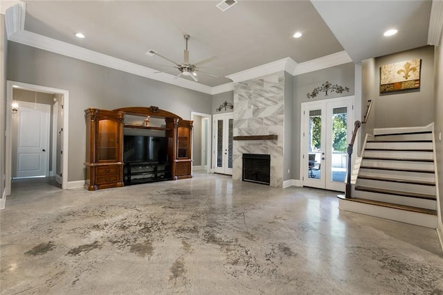 unfurnished living room with french doors, a towering ceiling, ornamental molding, ceiling fan, and a premium fireplace