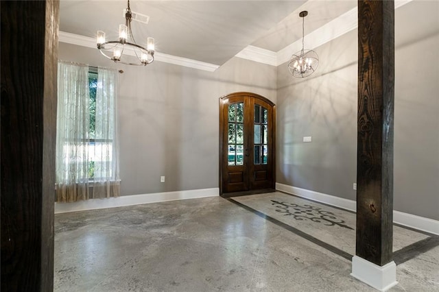 foyer featuring french doors, concrete floors, a wealth of natural light, and a notable chandelier