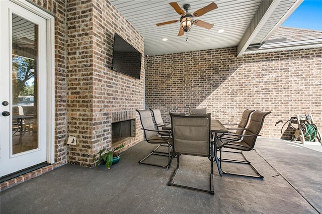 view of patio featuring ceiling fan and exterior fireplace