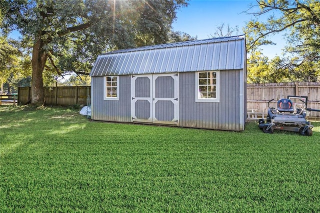 view of outbuilding featuring a lawn