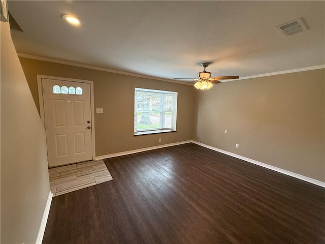 foyer featuring ceiling fan, dark hardwood / wood-style flooring, and crown molding