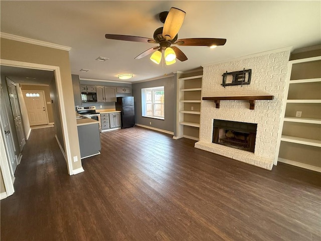 unfurnished living room featuring ceiling fan, a fireplace, crown molding, and dark wood-type flooring