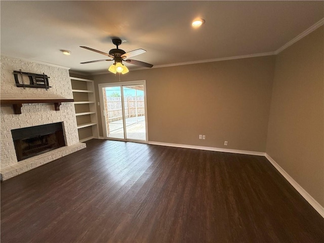 unfurnished living room with ornamental molding, ceiling fan, dark wood-type flooring, built in features, and a fireplace