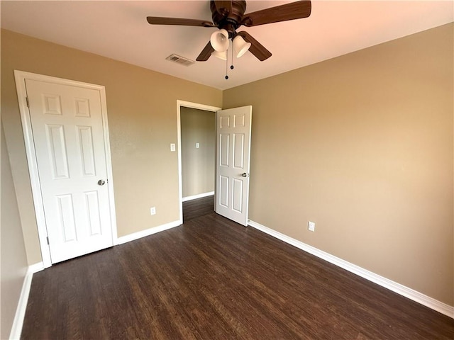 unfurnished bedroom featuring dark hardwood / wood-style flooring and ceiling fan