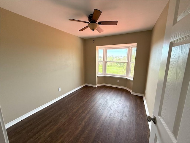 empty room featuring dark hardwood / wood-style floors and ceiling fan